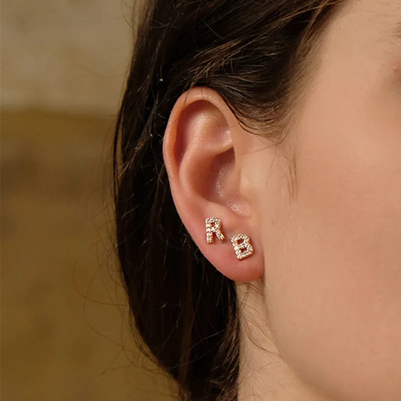 Gold plated alphabet letter earrings showing a single 'A' initial with clear zircon stone on a copper base.