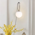 Nordic modern glass wall lamp with three light colour options on white wall