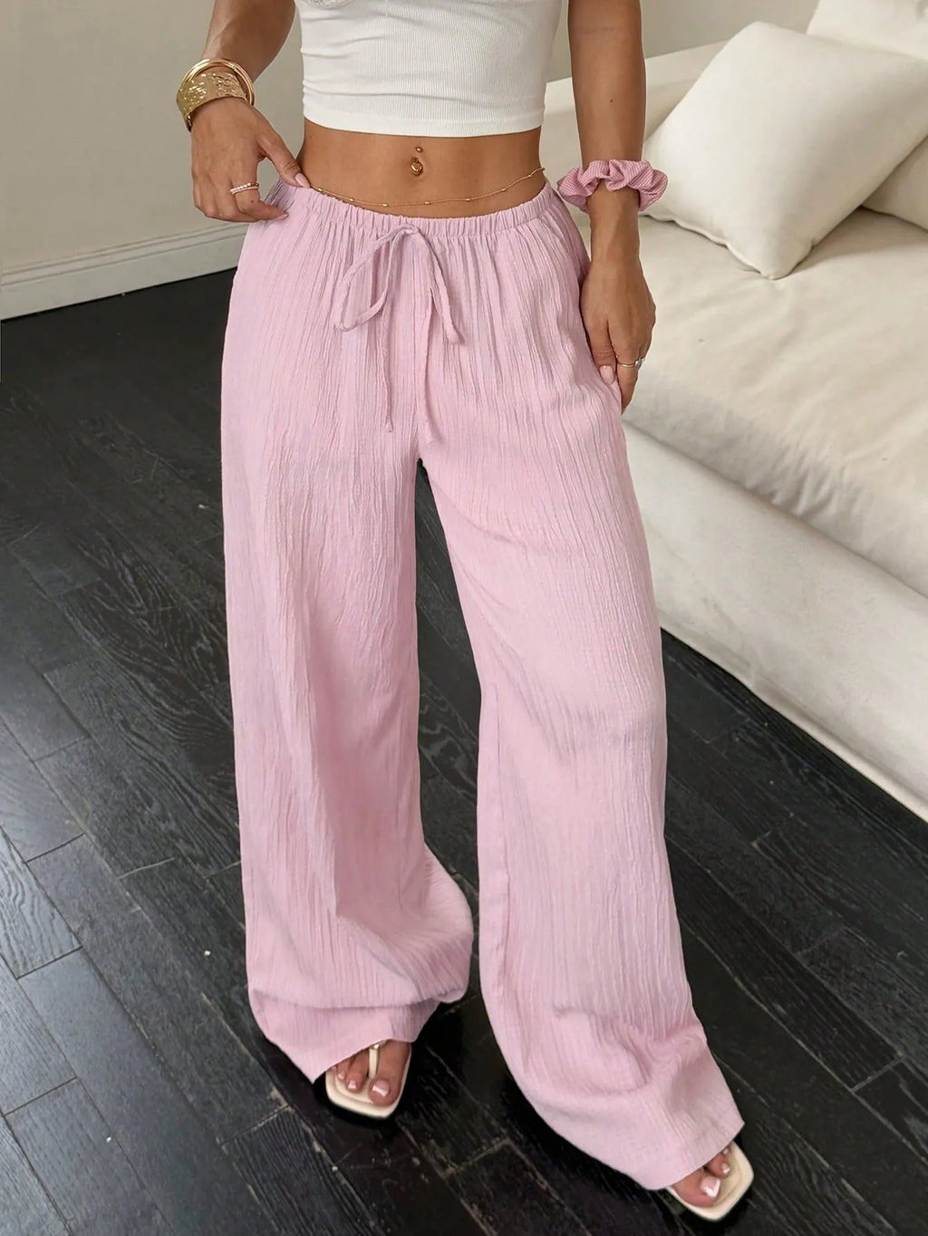 Women's black wide-leg trousers with lace-up waist trimming detail showing front view