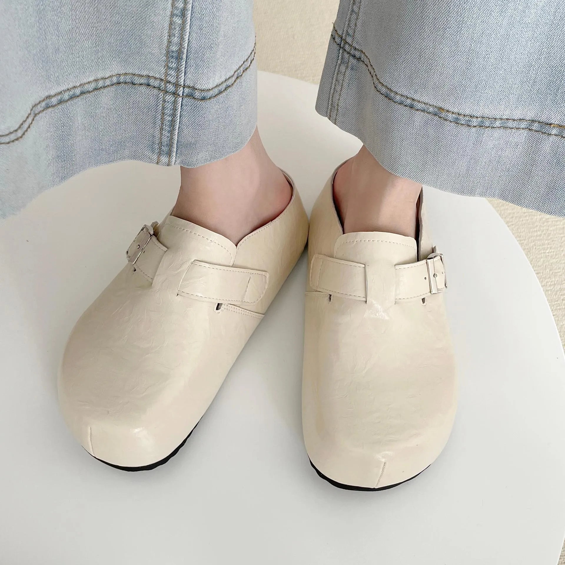 Flat casual sneakers with a buckle fastening and round toe in multiple colour options.