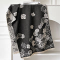 Long gray cashmere-like winter scarf with tassels laid flat showing its 185cm length