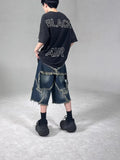 Blue denim shorts with frayed hem and five-pointed star detail, loose fit silhouette