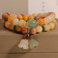 Dark green natural jinsi jade multi-layer bracelet with orchid pendant and adjustable sliding knot clasp.