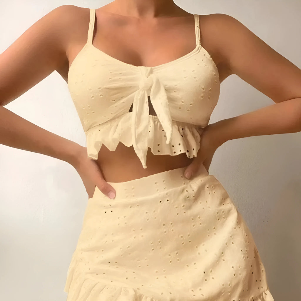Women's white split-hip skirt swimsuit three-piece bikini on a mannequin.