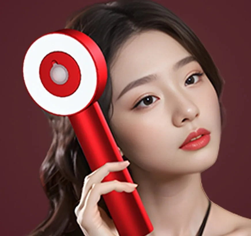 Black and red plastic electric massage comb for scalp with red and blue LED lights.