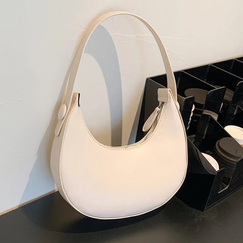 Retro dumpling-shaped women's shoulder bag in PU leather, showing sandwich pocket and cream yellow colour