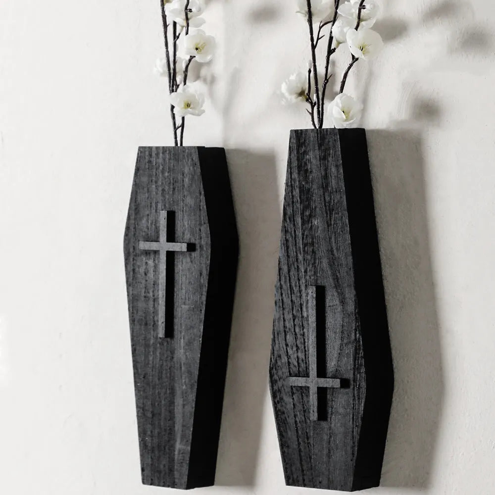 Black wooden cross wall shelf decoration measuring 27 cm by 9 cm.