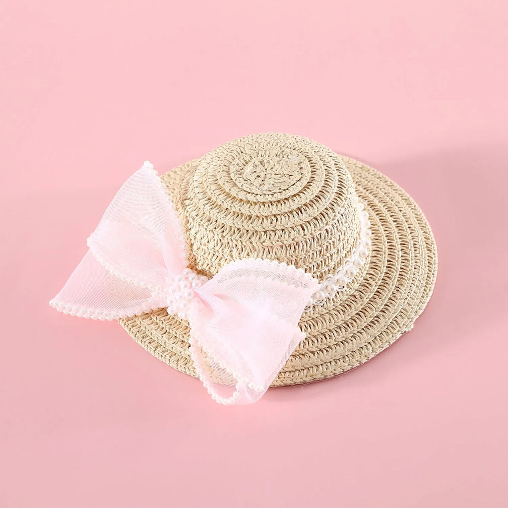 Pet cat wearing woven straw hat with pearl bow decoration in monochrome princess style