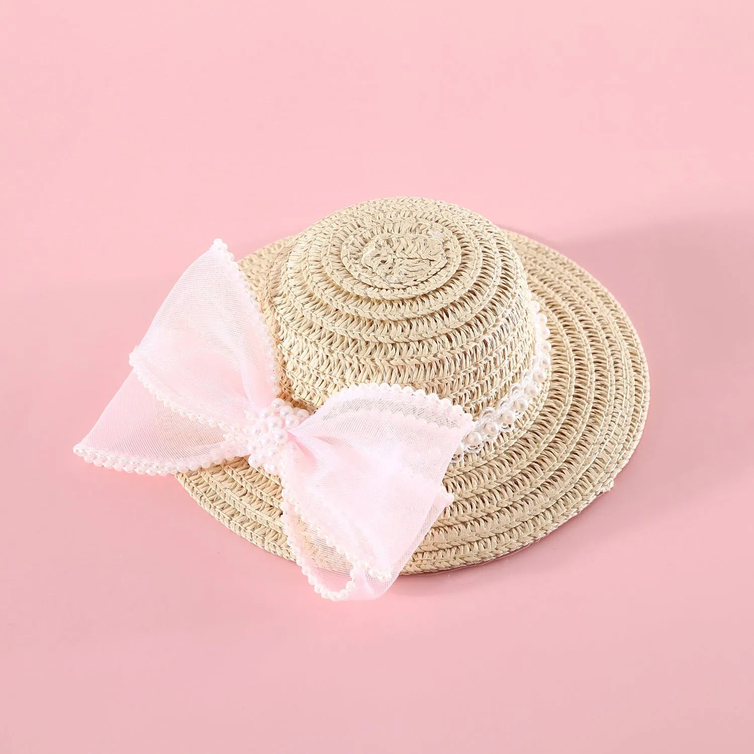 Pet cat wearing woven straw hat with pearl bow decoration in monochrome princess style