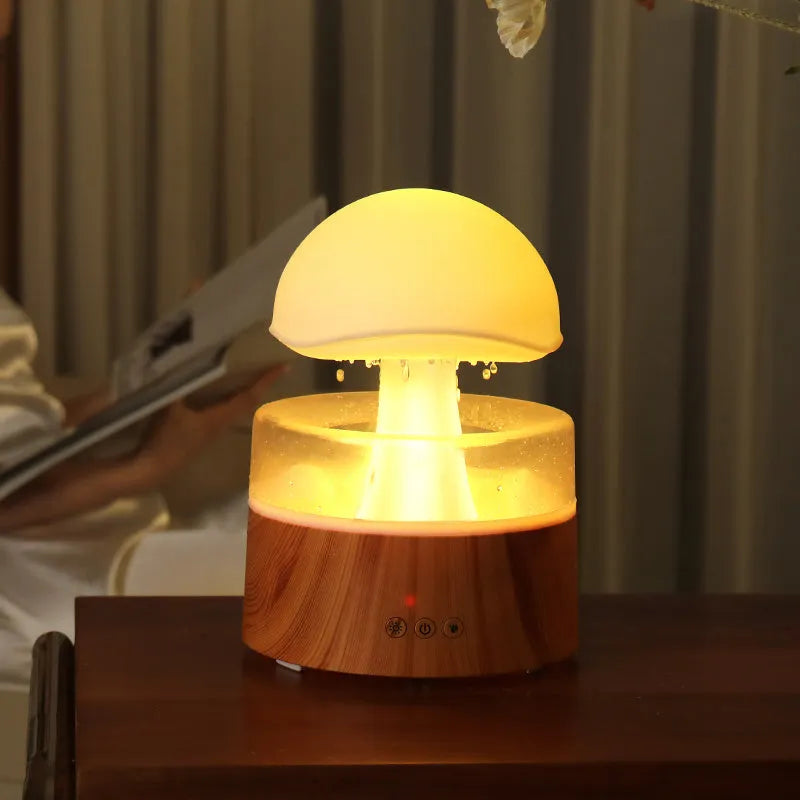 White cloud-shaped humidifier and aroma diffuser with coloured lights and simulated raindrops