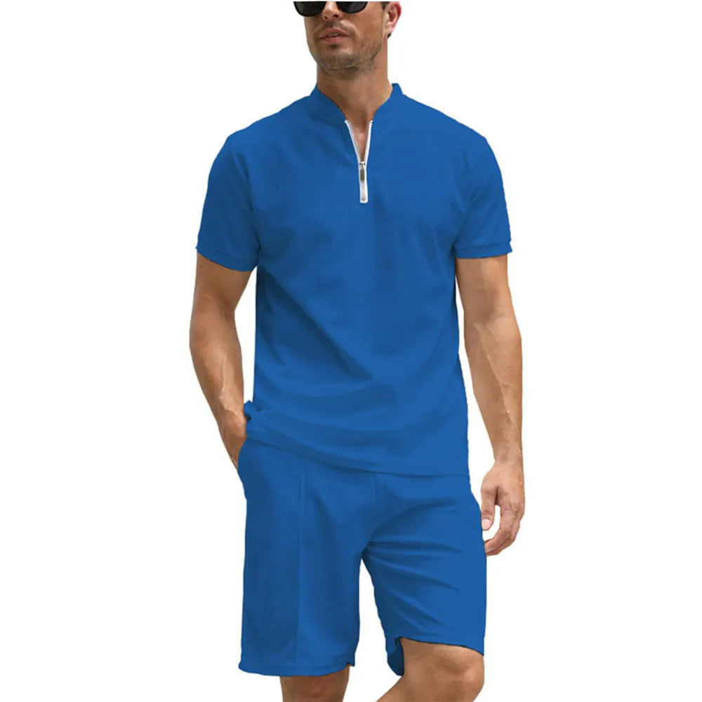 Men's solid colour polo shirt and matching trousers two-piece set on a hanger.