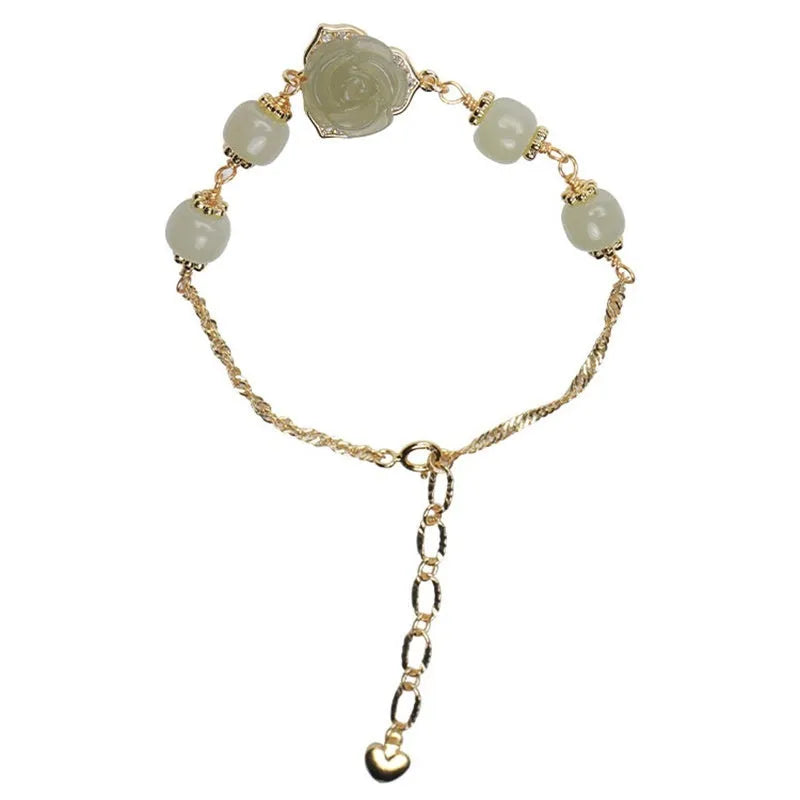 Close-up of a women's bracelet with a handmade Hetian Jade rose flower on a 14K gold plated band.