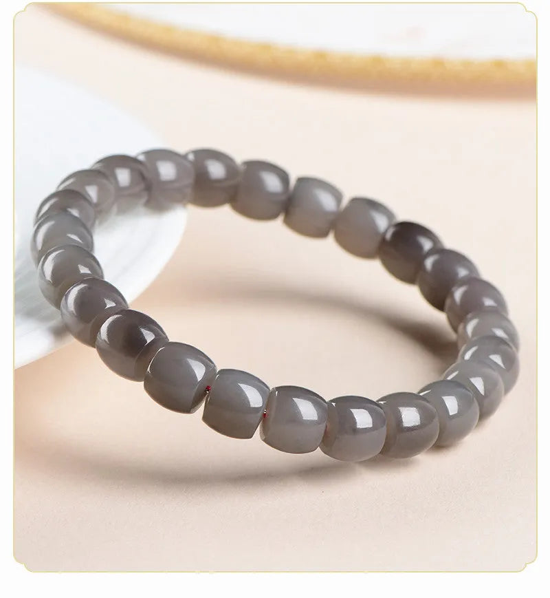 Straight cut smokey violet Hetian jade bracelet with approximately 24 beads measuring 8x9mm.