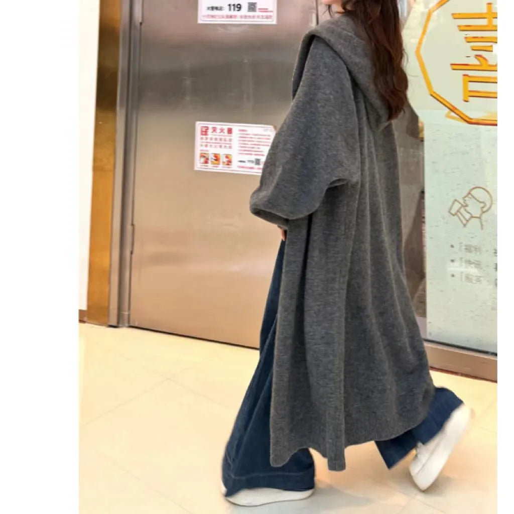 Korean style long hooded cardigan for women in oatmeal colour, showing below-the-knee length and loose fit.