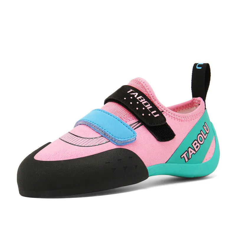 Beginner unisex rock climbing shoes with black and red colourway, showing Velcro strap and rubber sole.
