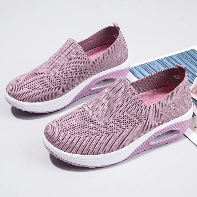 Women's black mesh running shoes with air cushion sole and round toe on a grey background.
