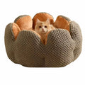 Green cactus petal shaped enclosed plush bed for a cat or small dog on a hardwood floor.