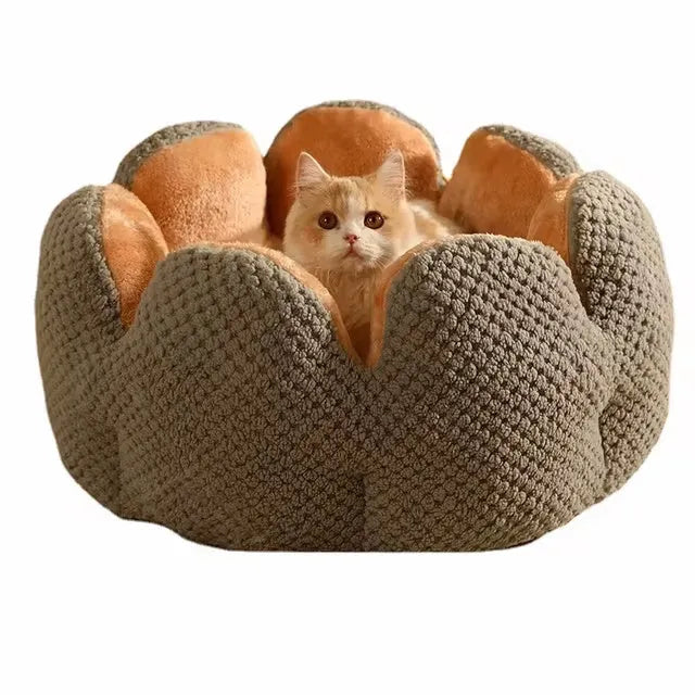Green cactus petal shaped enclosed plush bed for a cat or small dog on a hardwood floor.