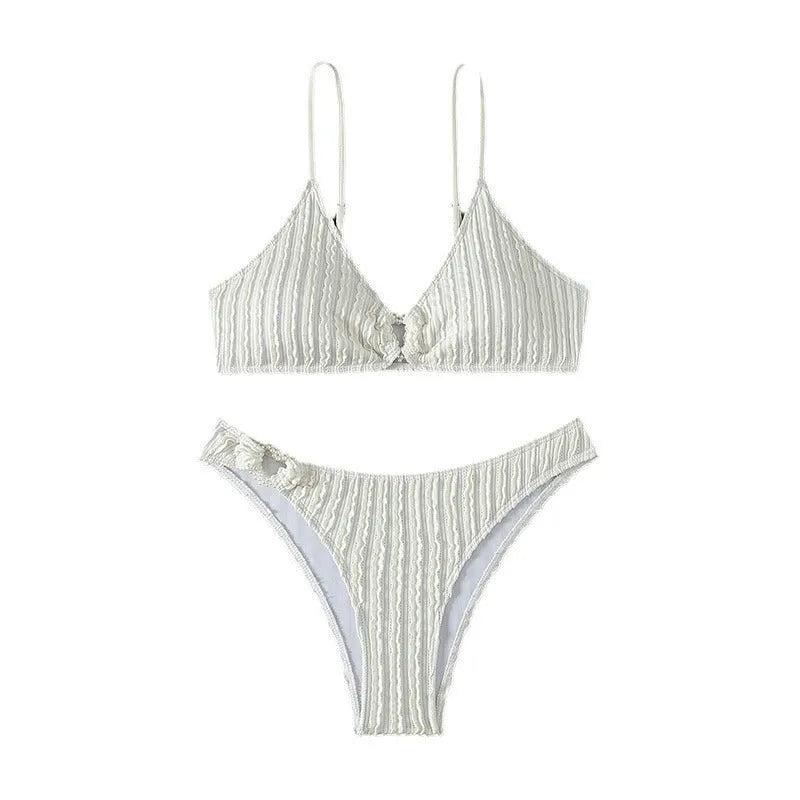 White women's V-neck sleeveless swim top with matching split beach shorts.