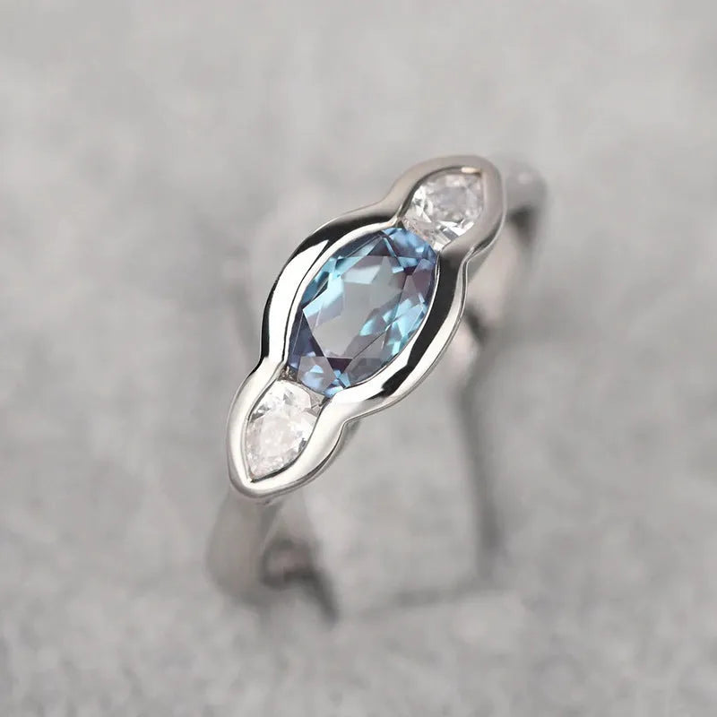 Geometric ellipse zircon ring in white gold colour showing structured design and stone inlay