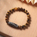 Simple Tigereye Dzi bead Buddha bracelet with single bead design on wrist