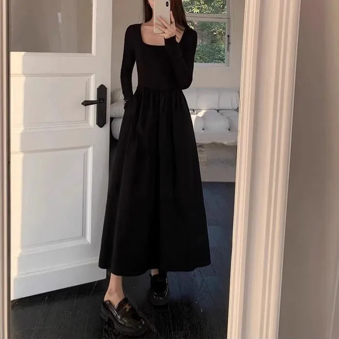 Women's black knitted A-line dress with square collar and long sleeves on hanger