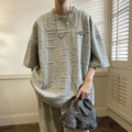 Men's loose fit grey t-shirt with a raised black three-dimensional retro letter print on the front.