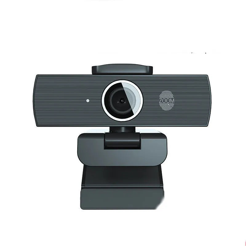 Black USB webcam on a desk with a detached magnetic privacy cover and a 1.7-metre cable