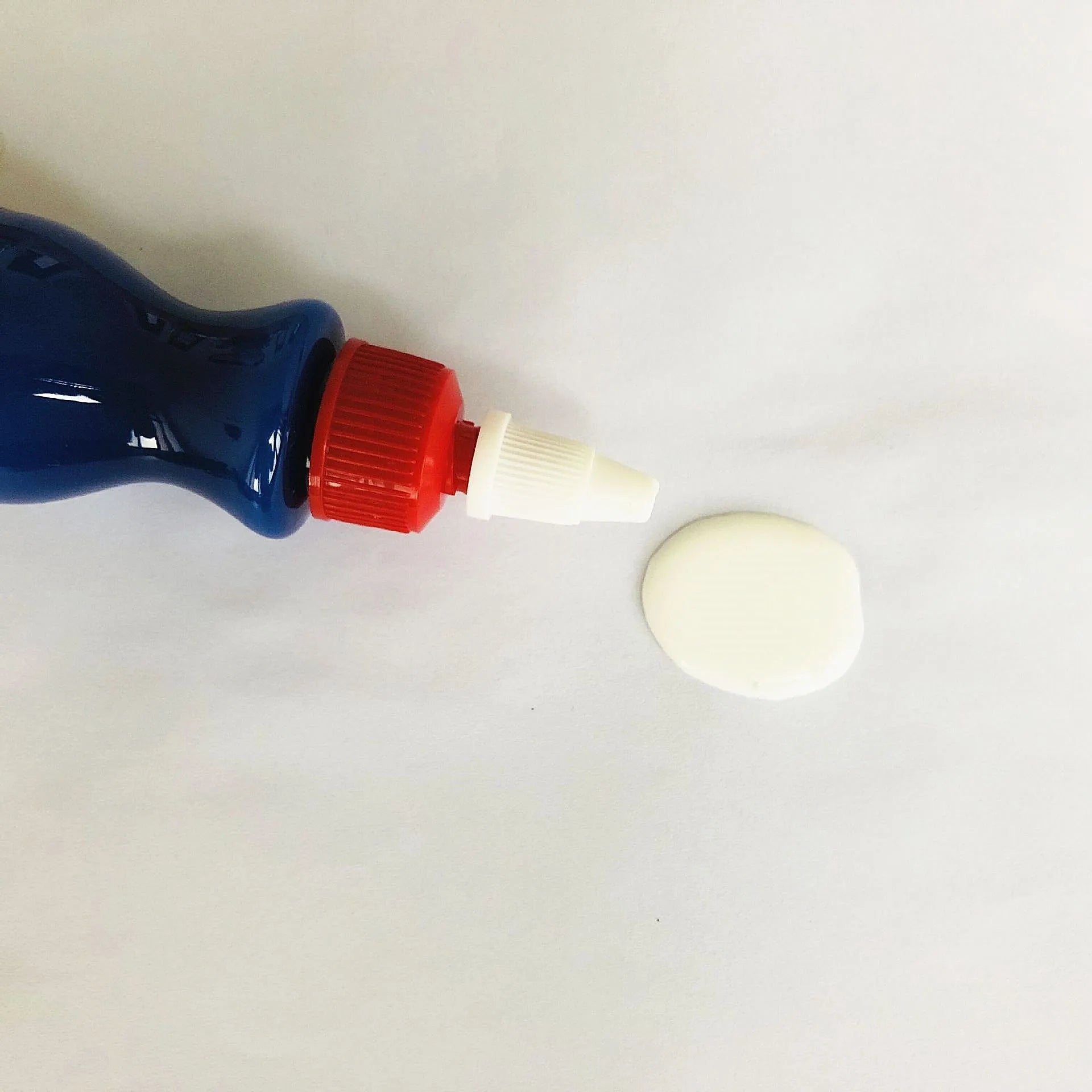 Blue car scratch repair cream bottle with applicator tool for automotive paint damage