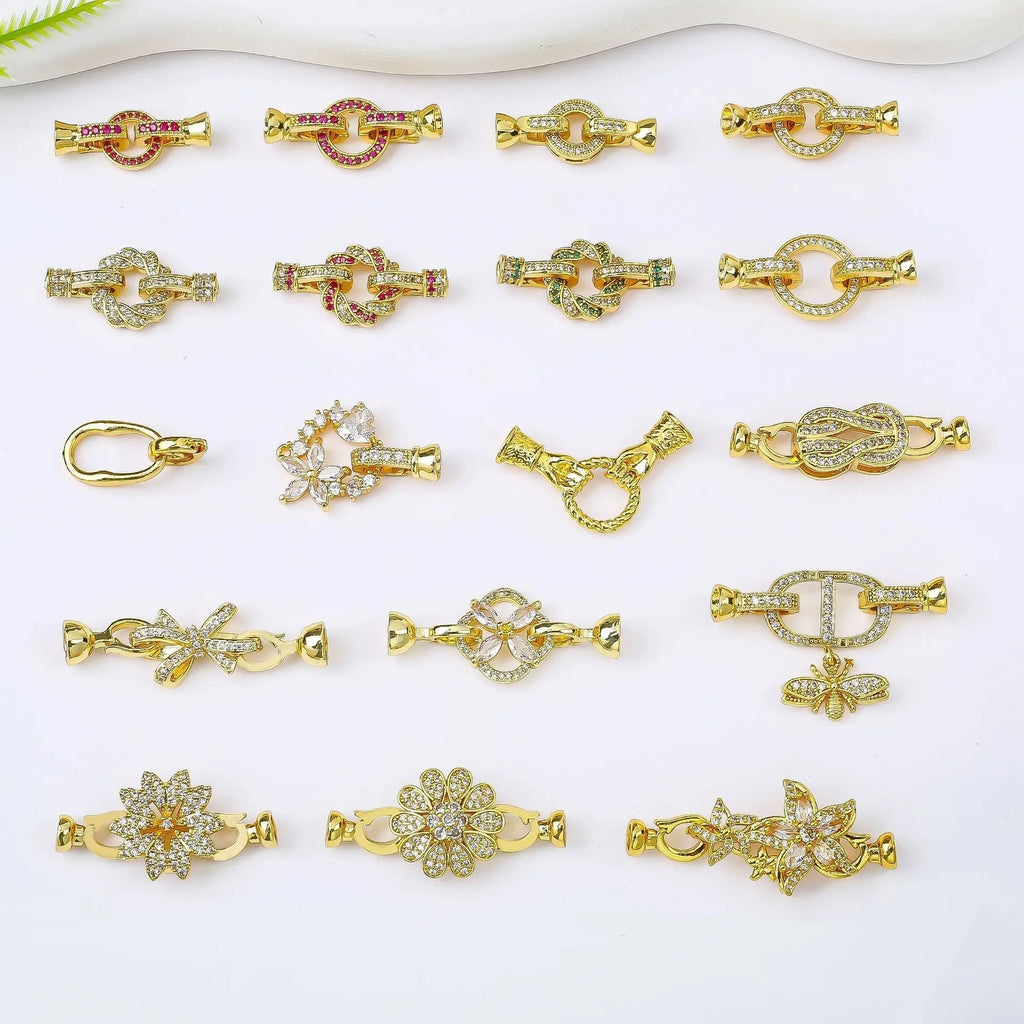 Small gold-colour metal jewellery clasp with a white pearl detail on the buckle