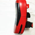 Red and black square hand-held martial arts training pad for kicks and punches.