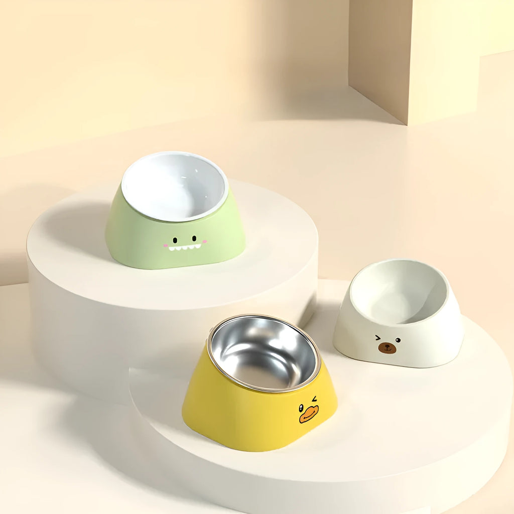 Green tilted stainless steel cat bowl with non-slip white base at a 15 degree angle
