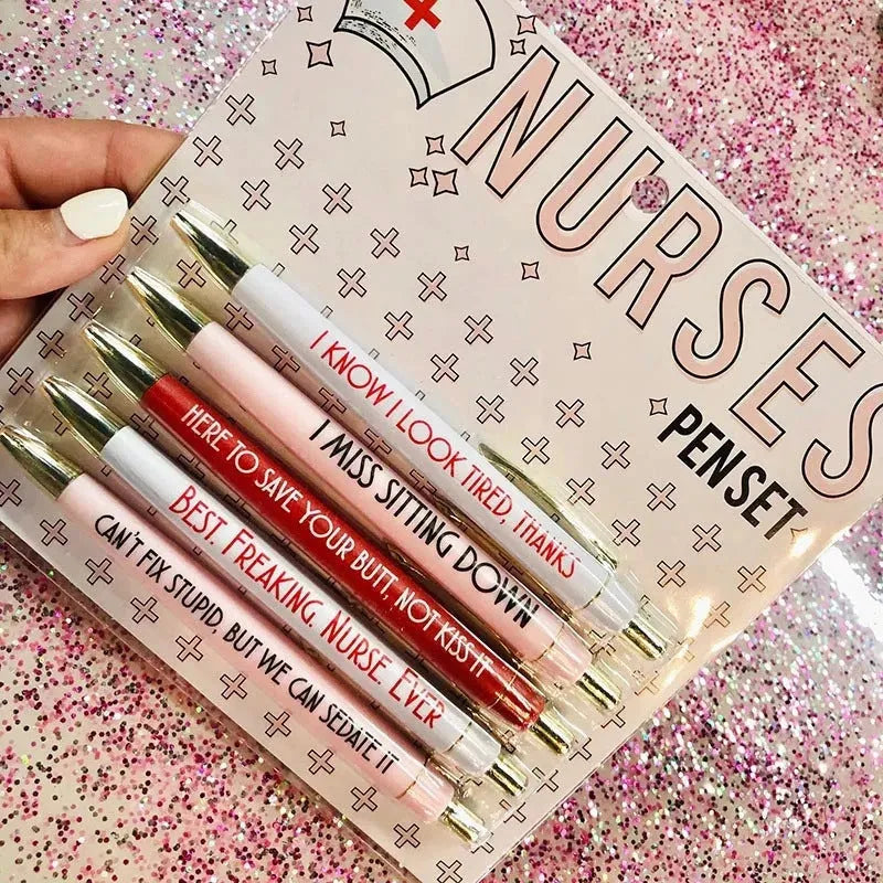 Set of five plastic nurse humour retractable ballpoint pens showing size.