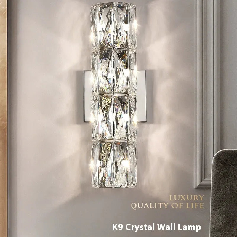 Slim crystal wall lamp with stainless steel body in chrome or gold finish, mounted on a wall.