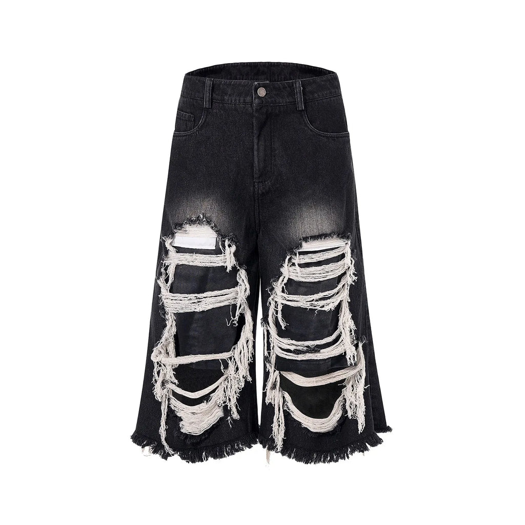 Black women's cropped wide leg jeans with ripped patch details and a mid-high waist.