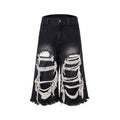 Black women's cropped wide leg jeans with ripped patch details and a mid-high waist.