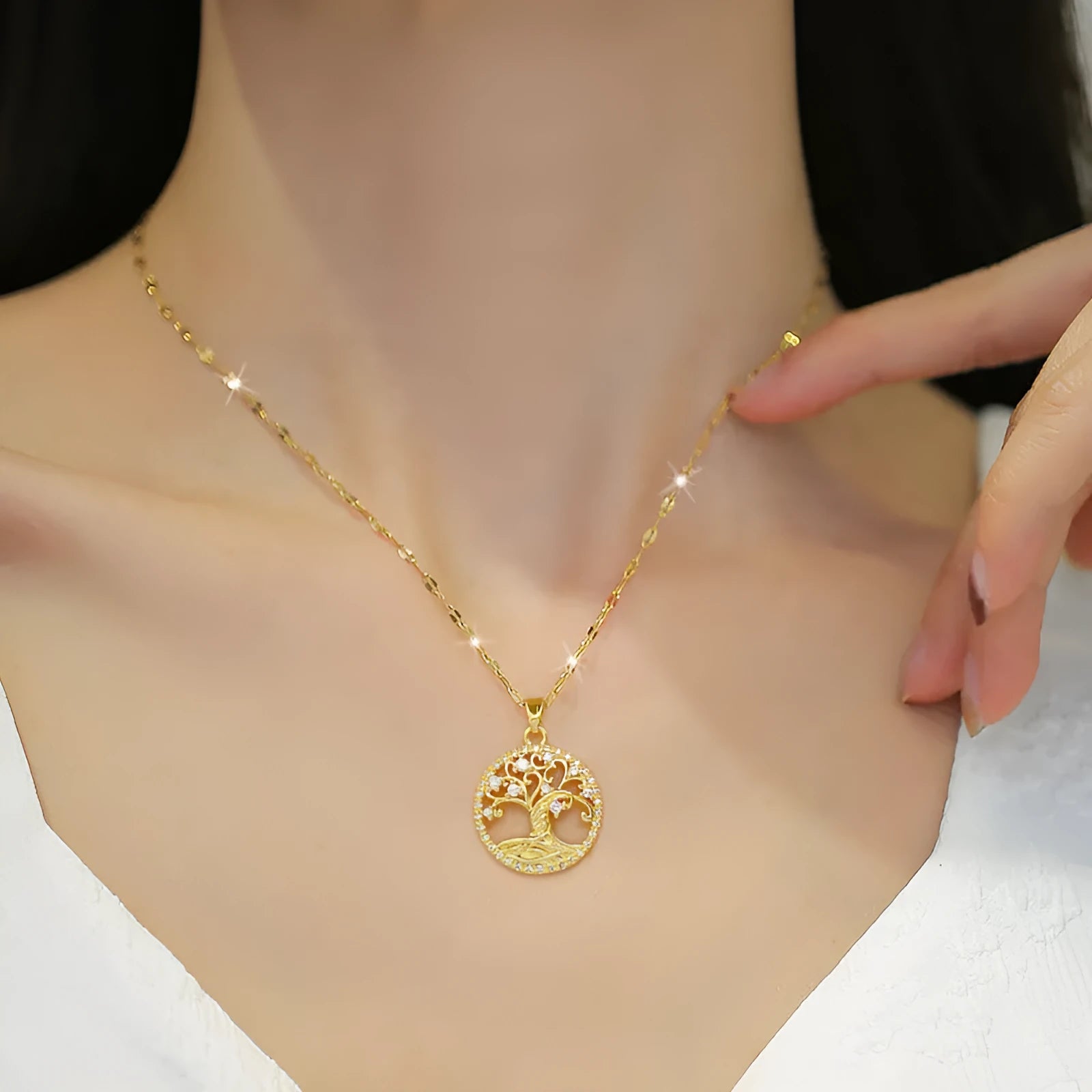 Gold-plated cross necklace with mother pearl pendant and full rhinestone detailing on adjustable stainless steel chain