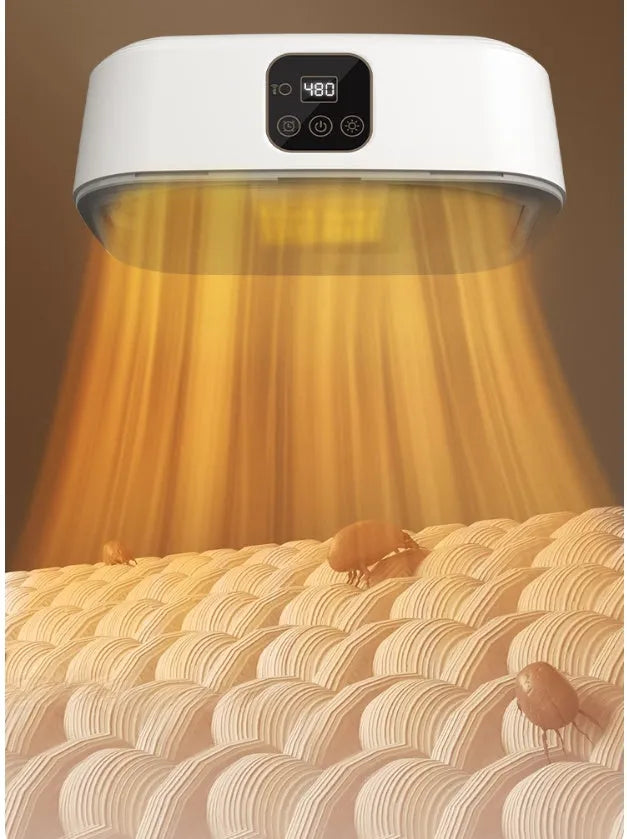 White cylindrical portable mini clothes dryer with remote control on a table.