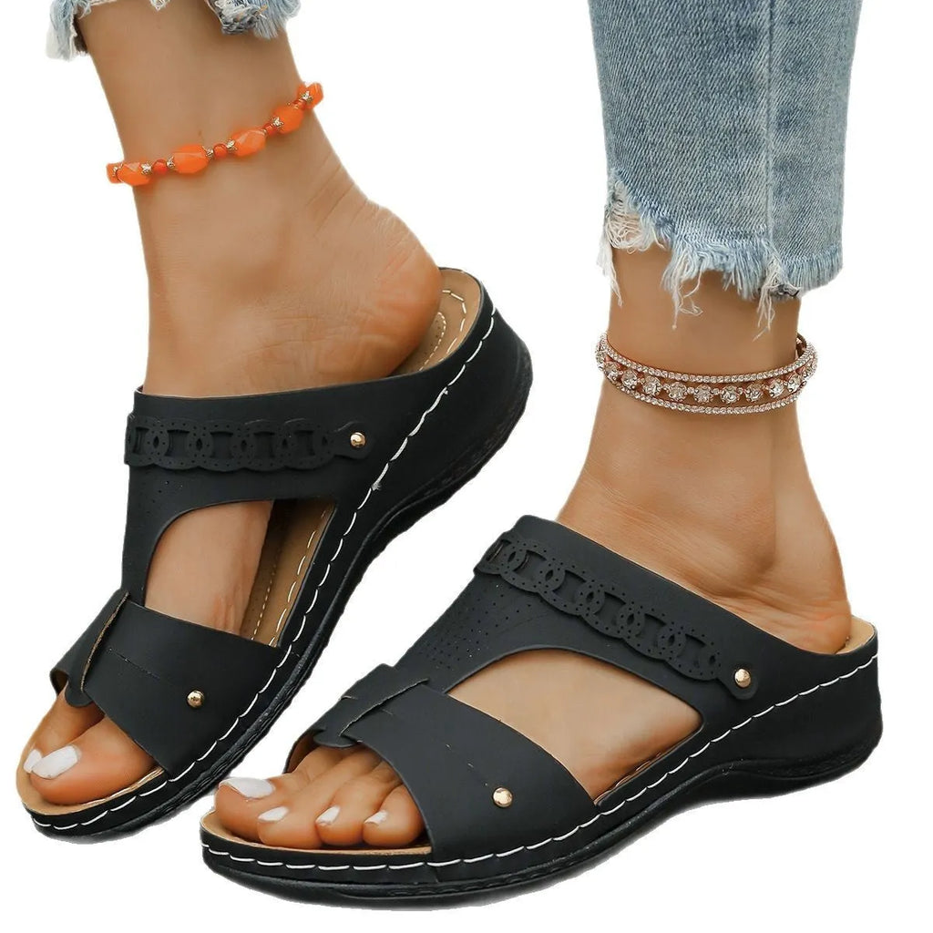 Roman style slope heel slippers with fish mouth toe in multiple colours on a rubber sole.