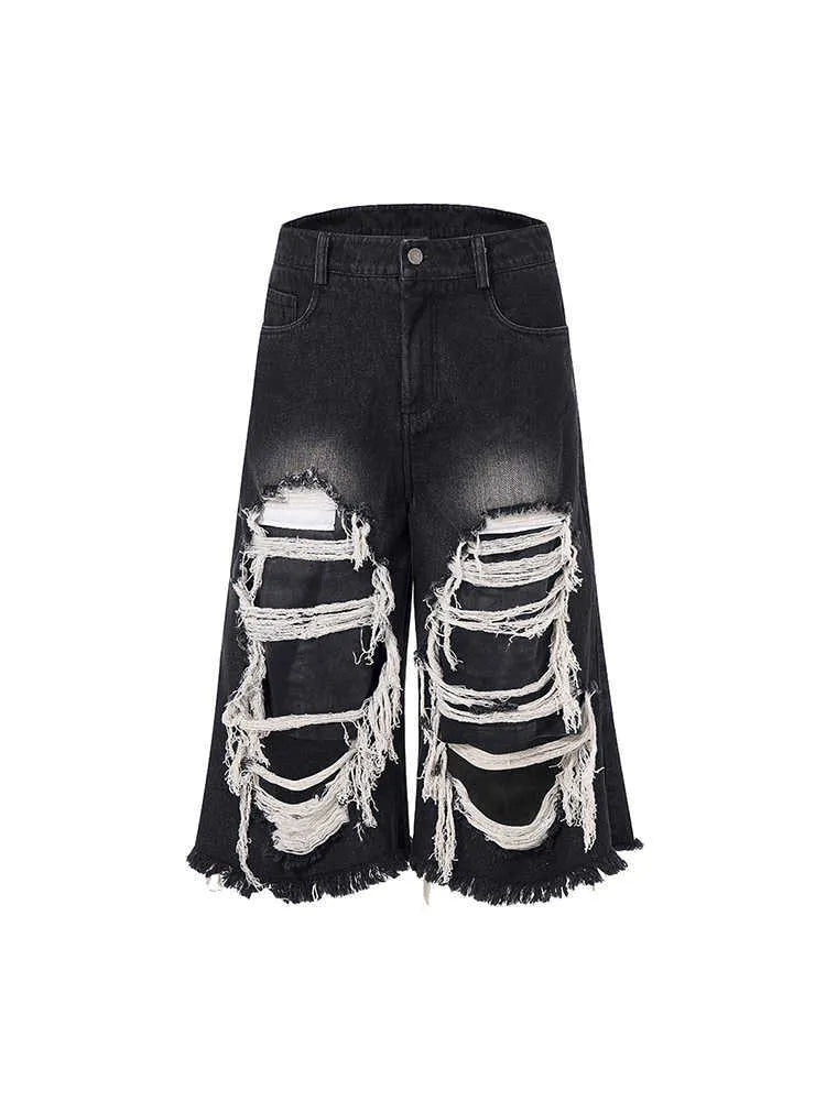 Black women's cropped wide leg jeans with ripped patch details and a mid-high waist.