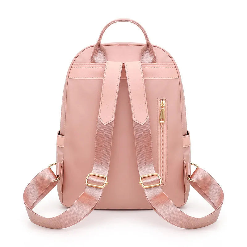 Women's casual nylon backpack in black or pink with water-resistant features and internal organisation compartments
