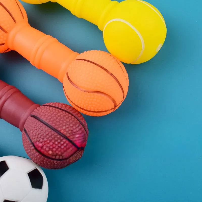 Brown, orange, white, and yellow PVC football dumbbell shaped dog squeaky toy on a white background.