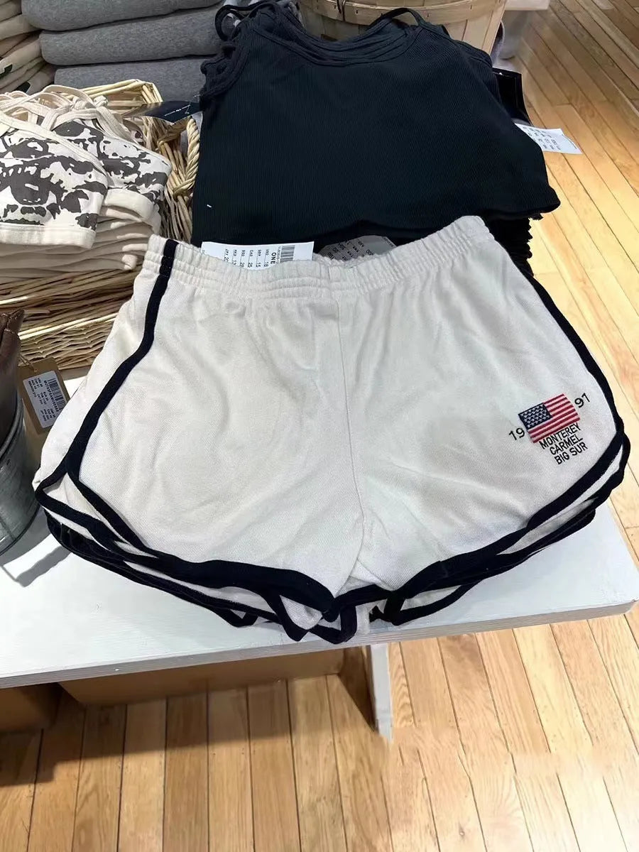 Women's dark blue cotton sports shorts with white flag embroidery and navy blue trim