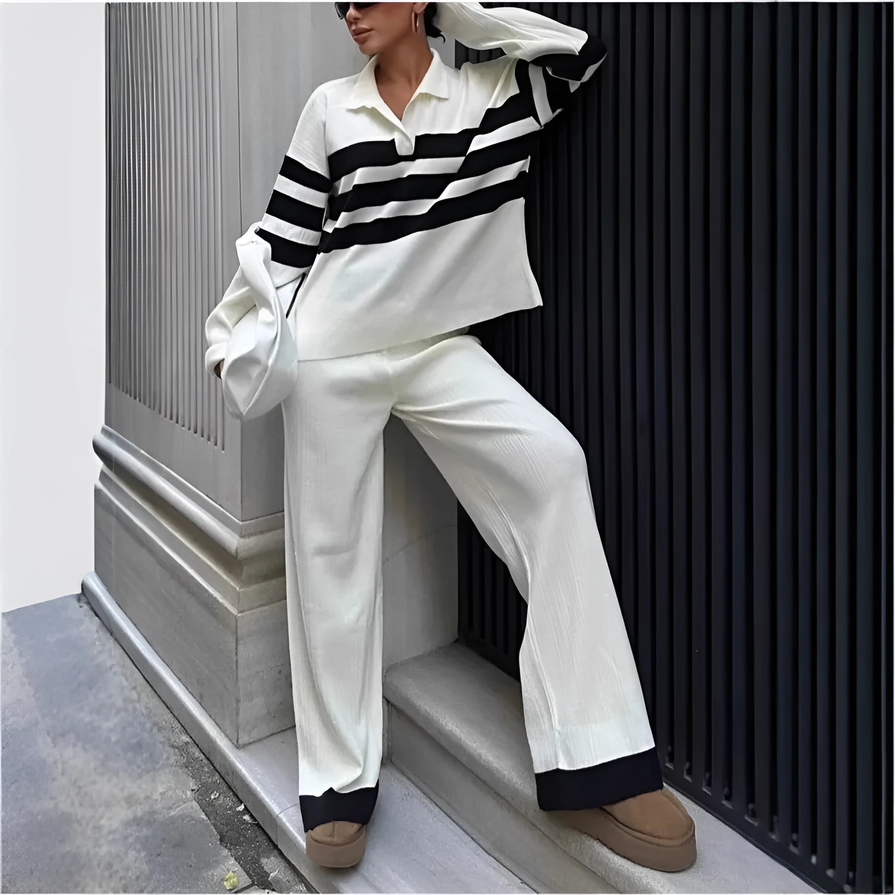 Women's black and white striped knitted two-piece set with polo collar top and matching trousers