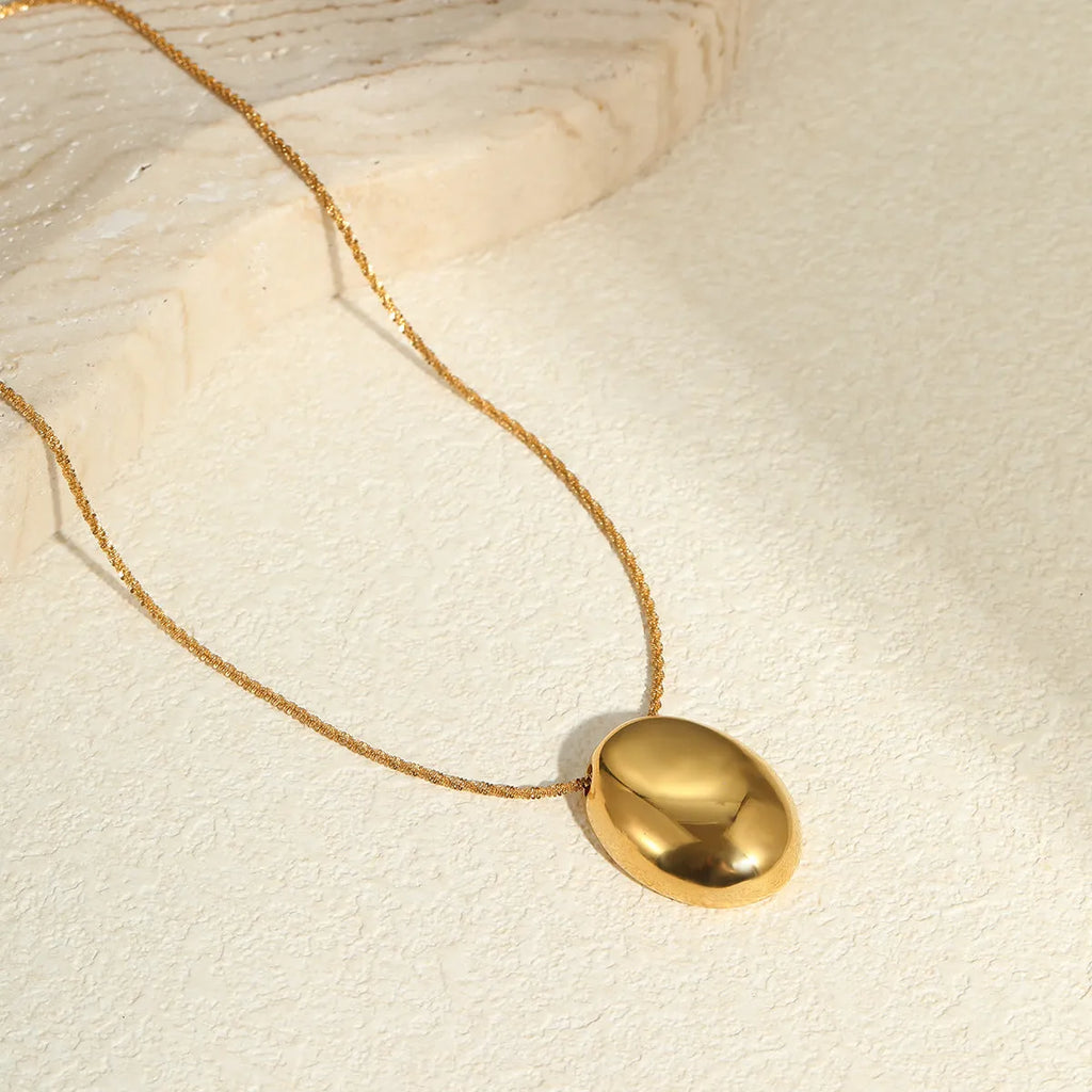 Gold-plated geometric pendant long necklace with adjustable chain on dark background