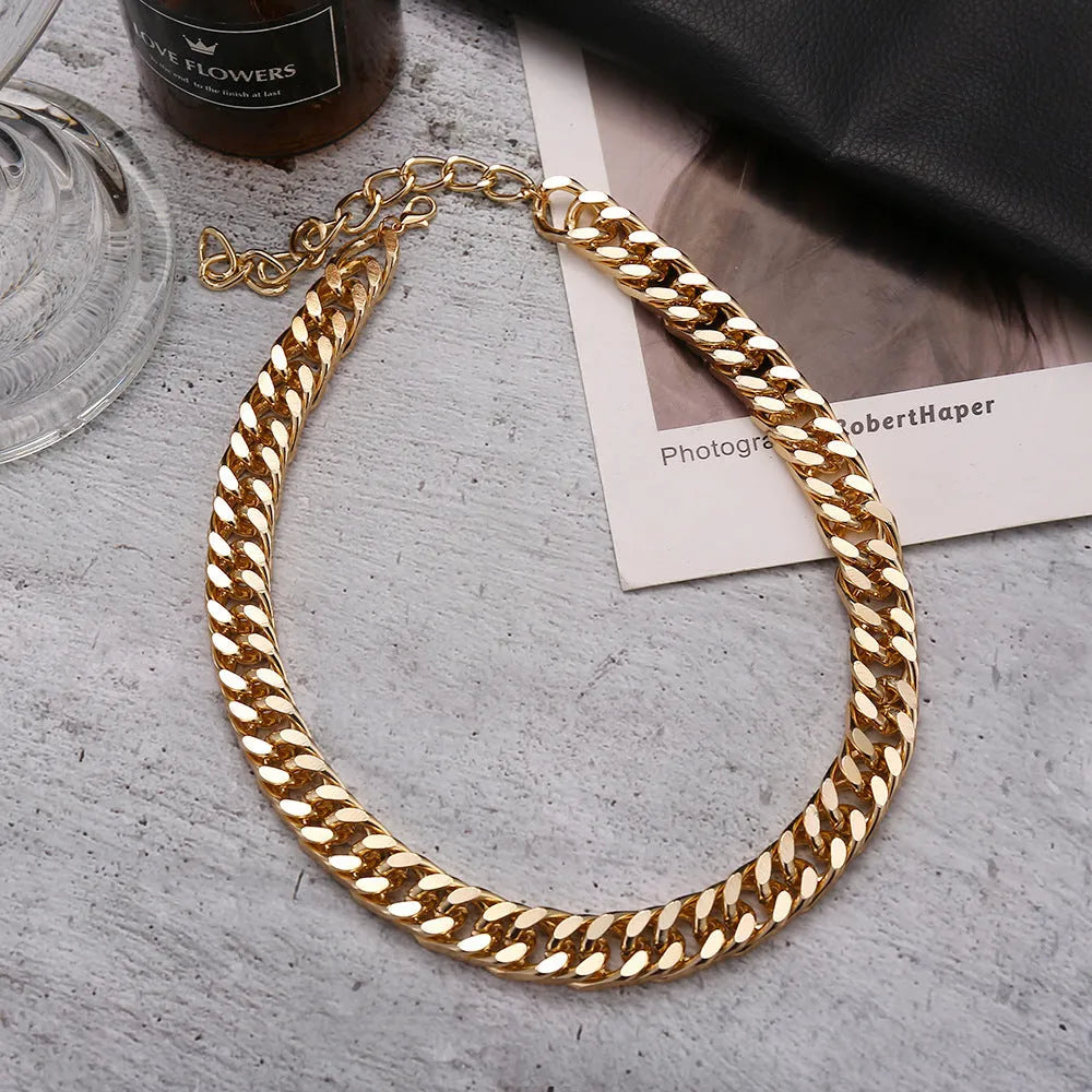 Women's gold tone thick chain necklace showing alloy construction with electroplated finish