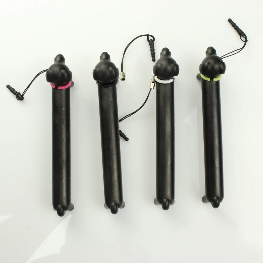 Black dog-shaped touch screen stylus pen shown next to a smartphone on a desk.