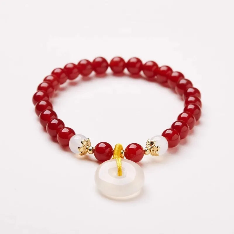 Handmade natural jinsi jade and red agate peace clasp bracelet with safety buckle on wrist.