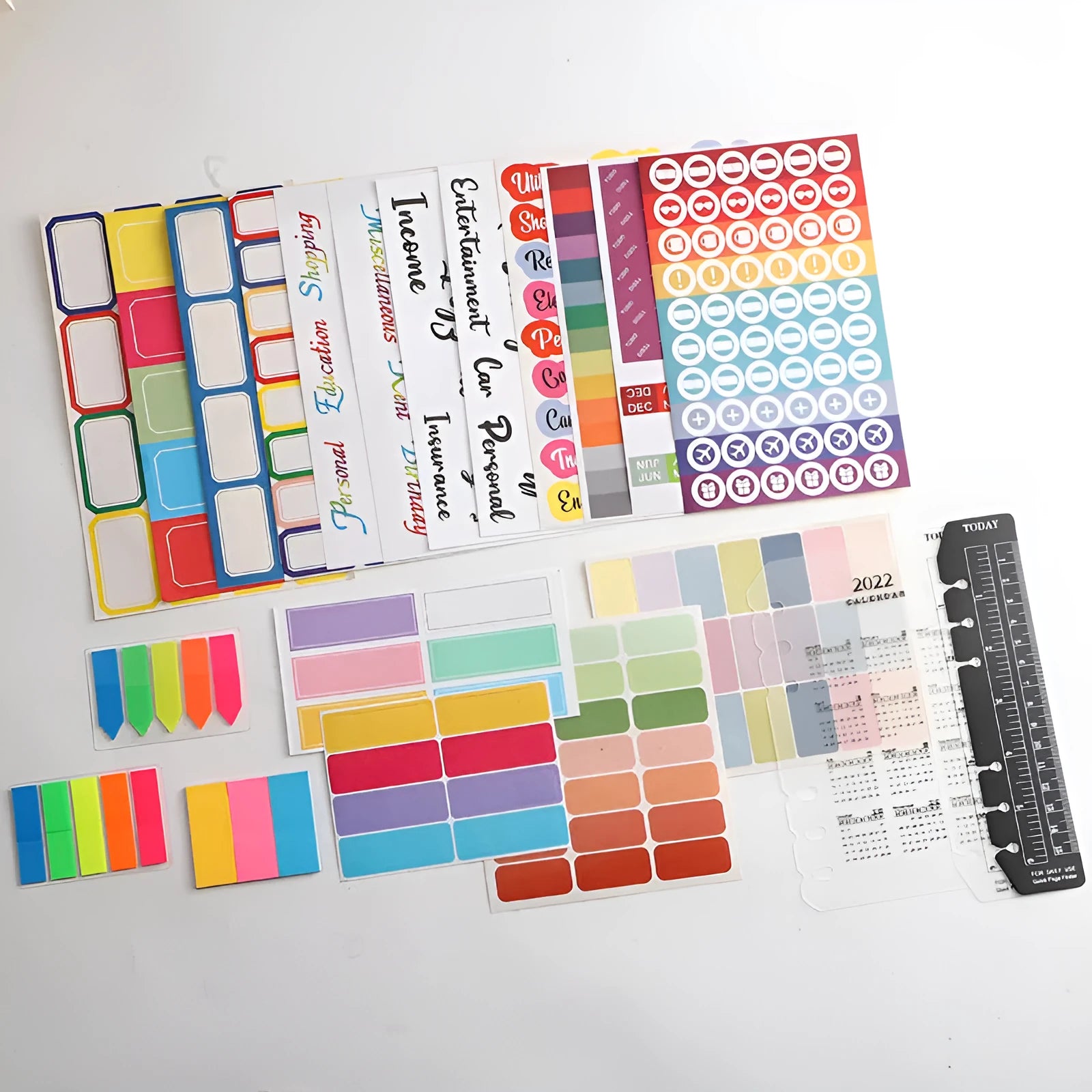 Assorted paper adhesive stickers including grid sheets, colourful sticky notes, and A6 ruler on a surface.
