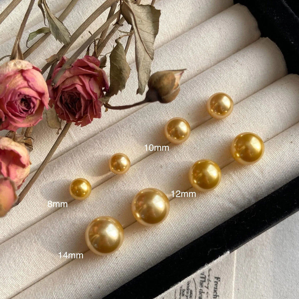 Close-up of retro-style geometric pearl stud earrings in silver, showing eight-awl star detail.